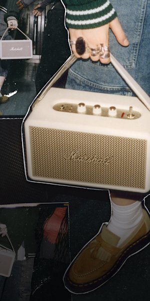 The Kilburn III Cream held by its strap