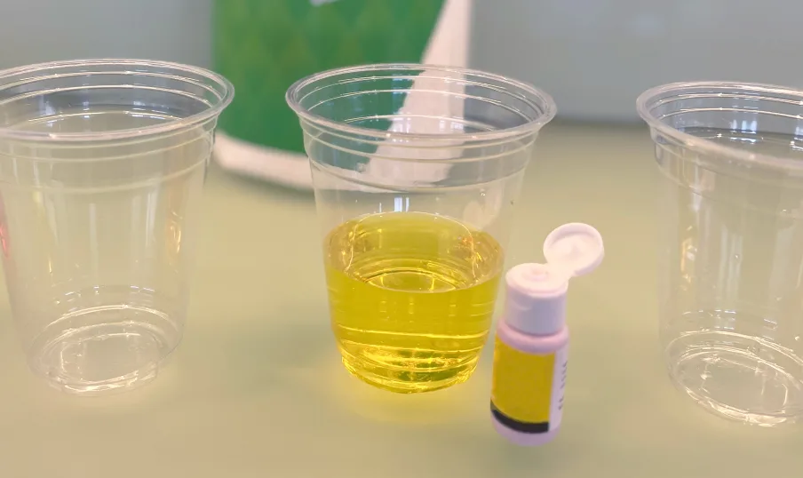Yellow food coloring in the third cup of water