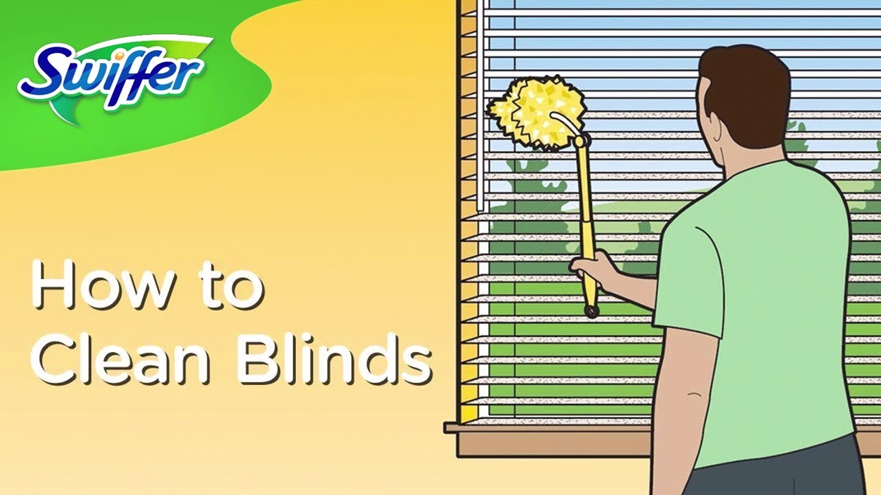 How to Clean Blinds - A man using a Swiffer duster to clean window