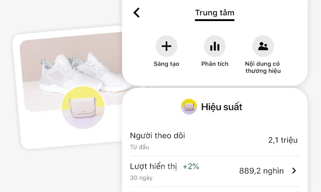 Ảnh chụp màn hình Cộng đồng người tạo của Pinterest trên di động, có tùy chọn Sáng tạo, Phân tích, Nội dung có thương hiệu. Bên dưới là phần Hiệu suất hiển thị người theo dõi và lượt hiển thị. Phía sau là hồ sơ người bán cách điệu có giày thể thao trắng.