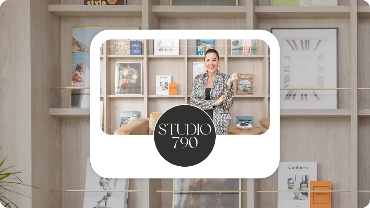 A woman sitting in front of a wall of square bookshelves aesthetically arranged with books and a clock. Logo in front says "Studio 790" in white text on a black background.