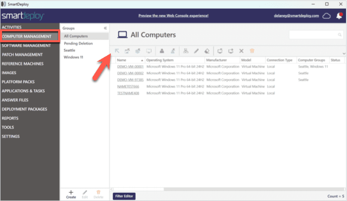 Screenshot of the SmartDeploy interface in the "Computer Management" section, highlighted in the left navigation panel. The main view is titled "All Computers" and displays a list of managed computers with details such as Name, Operating System, Manufacturer, Model, Connection Type, and Computer Groups. An arrow points to the left side of the window, indicating the "Computer Management" menu category. A group list on the left includes "All Computers," "Pending Deletion," "Seattle," and "Windows 11." The top bar shows the user's email and a link to preview the new Web Console experience.