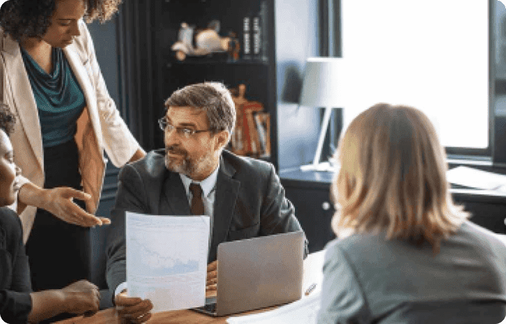 Older man receiving financial advice from several women