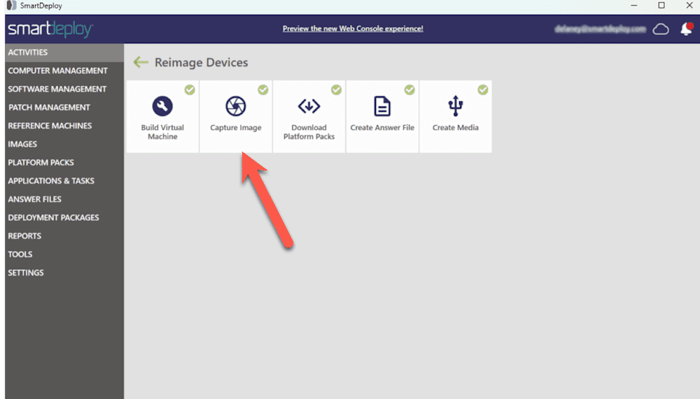 Screenshot of the SmartDeploy interface under the "Reimage Devices" section. A red arrow points to the "Capture Image" tile, which is located between the "Build Virtual Machine" and "Download Platform Packs" options. The left sidebar shows the main navigation categories such as Activities, Computer Management, Software Management, and others. The header includes a link to preview the new Web Console experience and shows a user logged in at the top right.