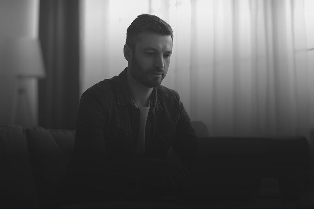 black and white image of man sitting