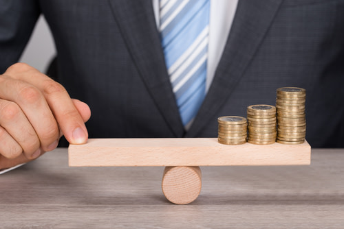Businessman Balancing Money