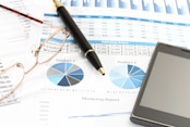 Pen on stock graph with tablet