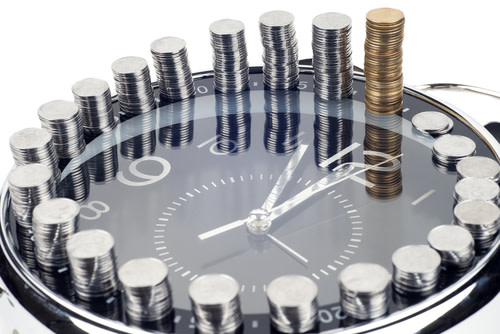A clock with stacks of coins for hours.