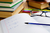 Notebook with math and pen on top