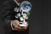 Man holding house, world and stock icons in hand