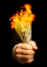 Man holding burning dollars
