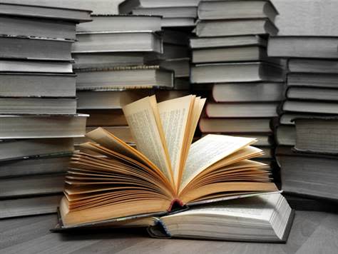 Black and white and color books on a desk