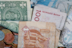 Different foreign currency in a pile.