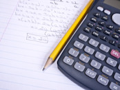 Calculator and pencil on sheet of paper