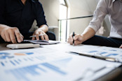 Business men looking over financial data