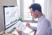 Man sitting and reviewing charts