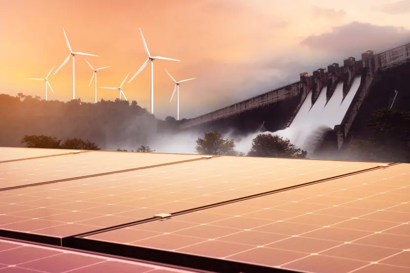 Alcuni pannelli solari, delle turbine eoliche e una cascata a rappresentare le diverse fonti di energia rinnovabile.