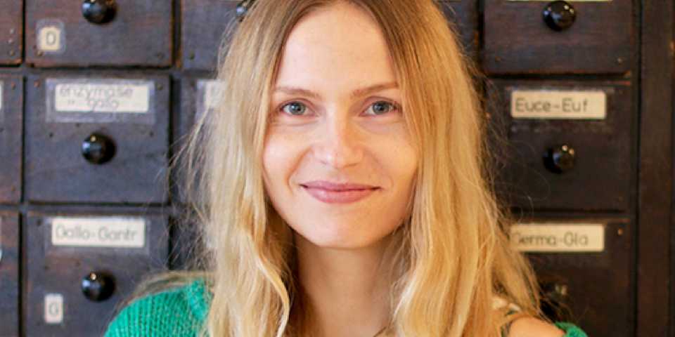 portrait of vanessa stock standing in front of locker with wooden drawers in the clue office