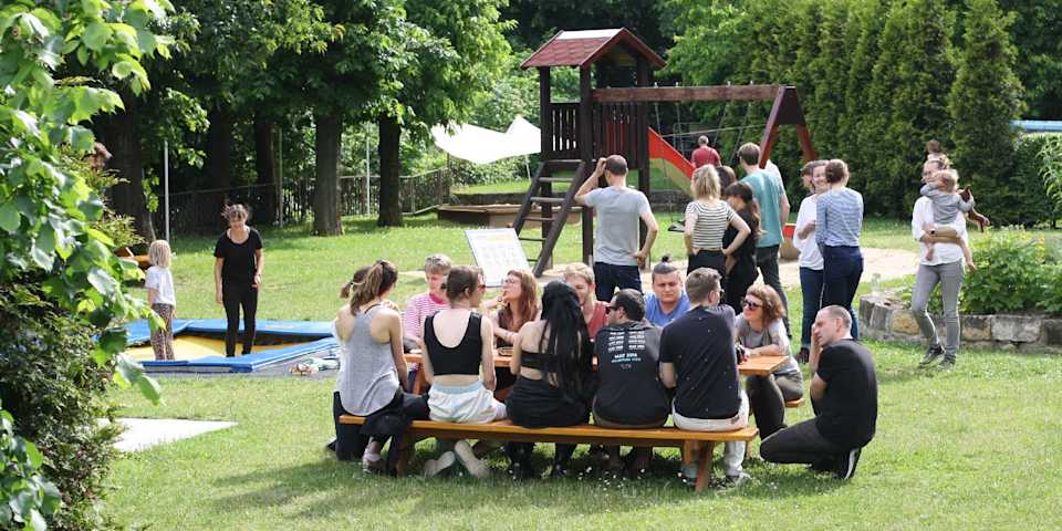 people sitting around table garden trampolin
