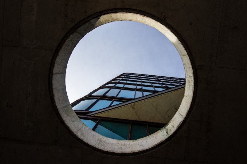 Image of a view towards the top of a building through a circular aperture 