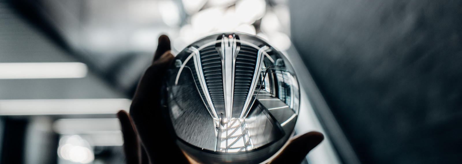 Image of a crystal ball being held up by a hand
