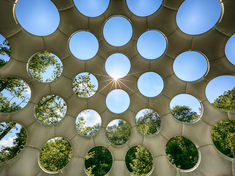 Image looking out to the world through a series of circular portholes