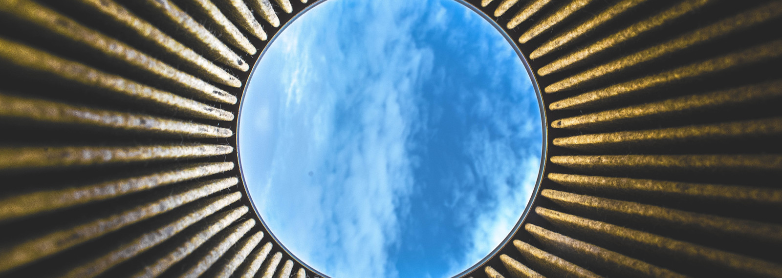 Looking up to the open sky through a circular building