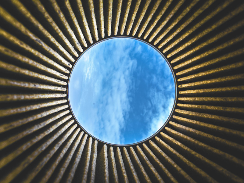 Looking up to the open sky through a circular building