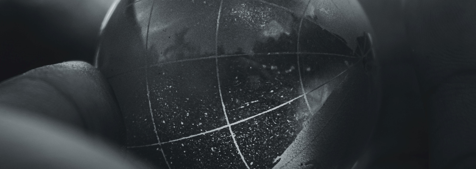 Image of a transparent globe held in a hand