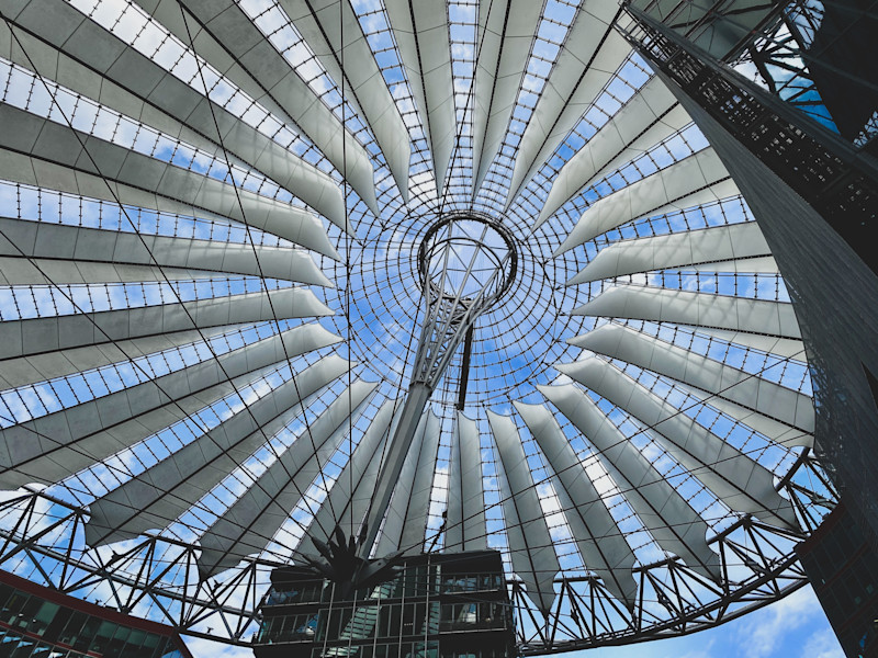Image looking up into the inside of a circular glass structure