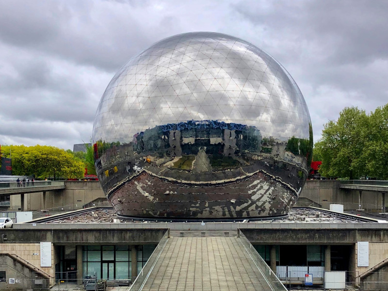 Image looking through a giant transparent sphere to a city scape