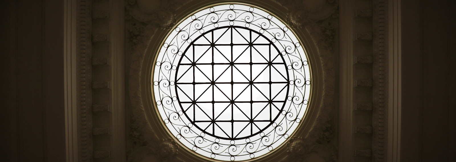 Looking up through a circular window in a roof