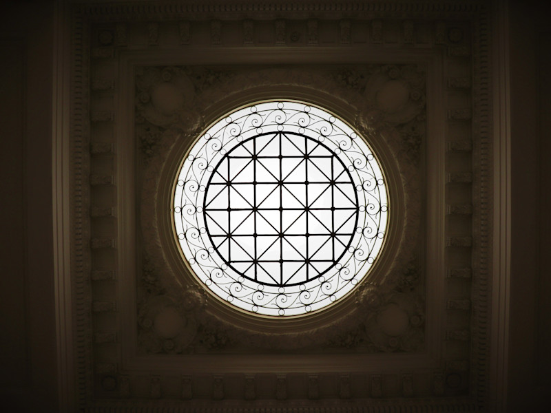 Looking up through a circular window in a roof