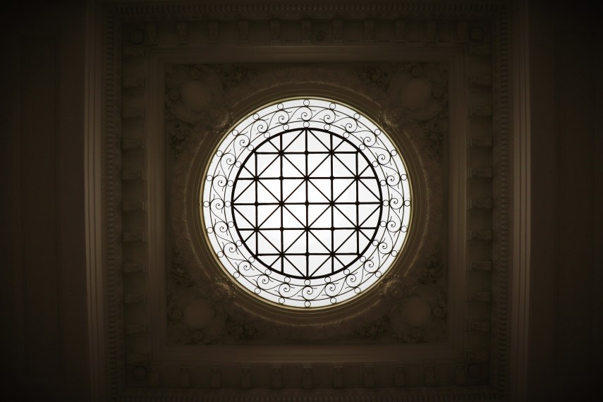 Looking up through a circular window in a roof