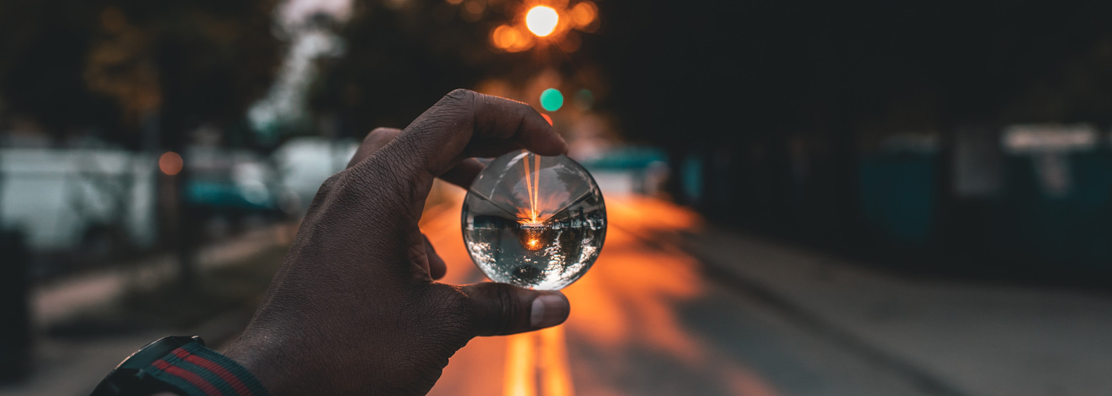 Image looking through a spherical glass ball at a street