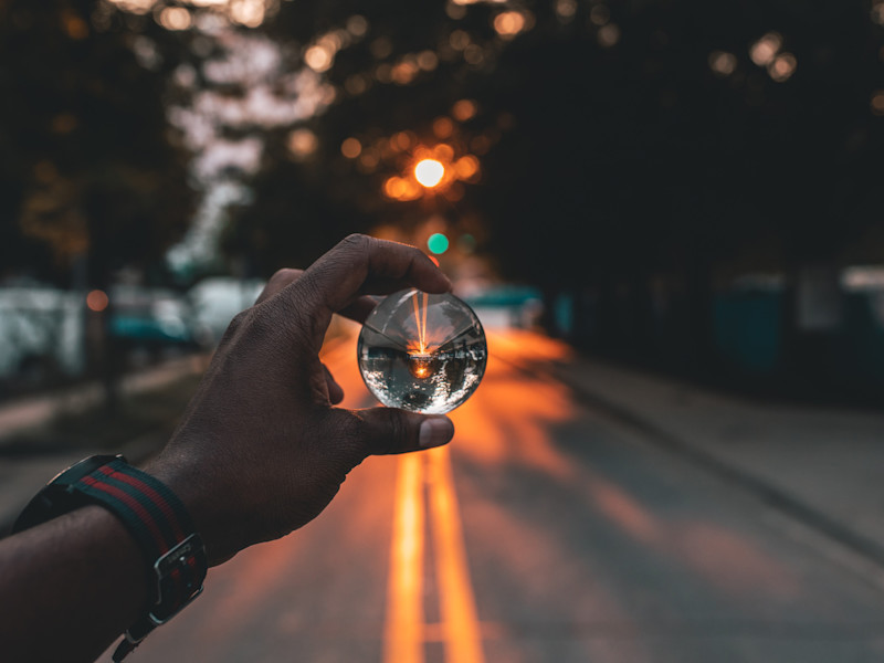 Image looking through a spherical glass ball at a street