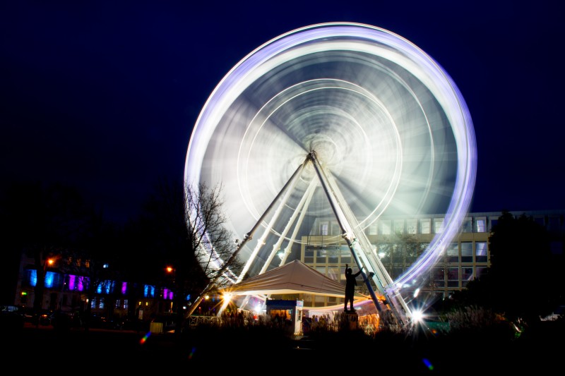 Image of an illuminated Ferris wheel in a night scene