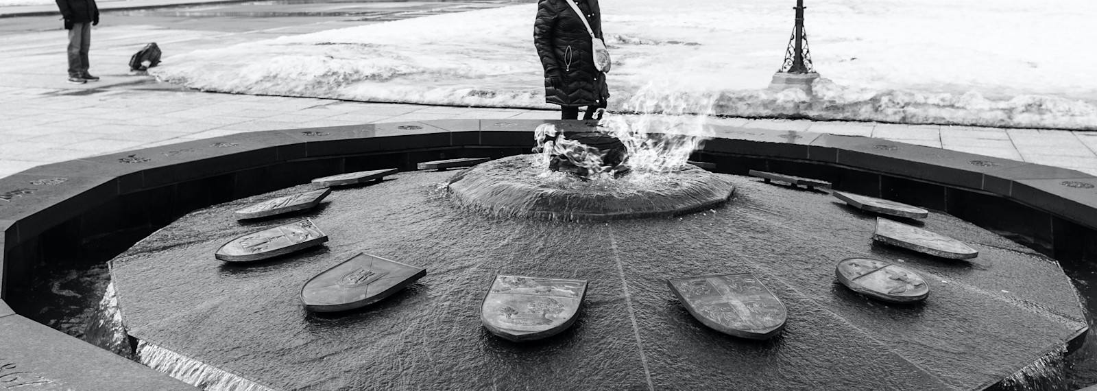image of a close up of a circular fountain in a pedestrian square