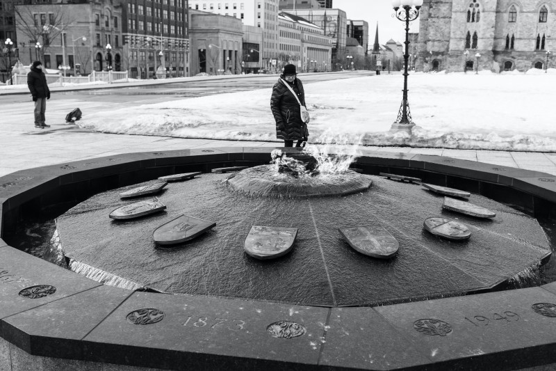 image of a close up of a circular fountain in a pedestrian square