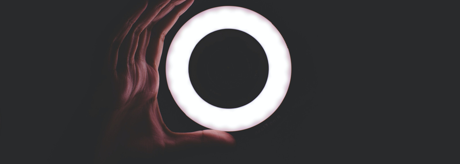Hand holding circular light