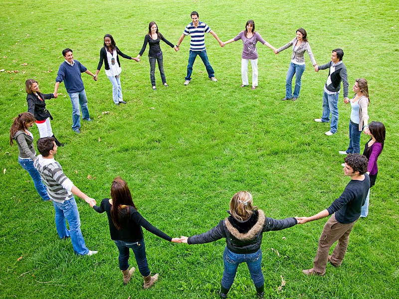 Image of a group of people standing in a circle