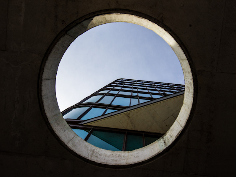Looking up at a building through a circular aperture