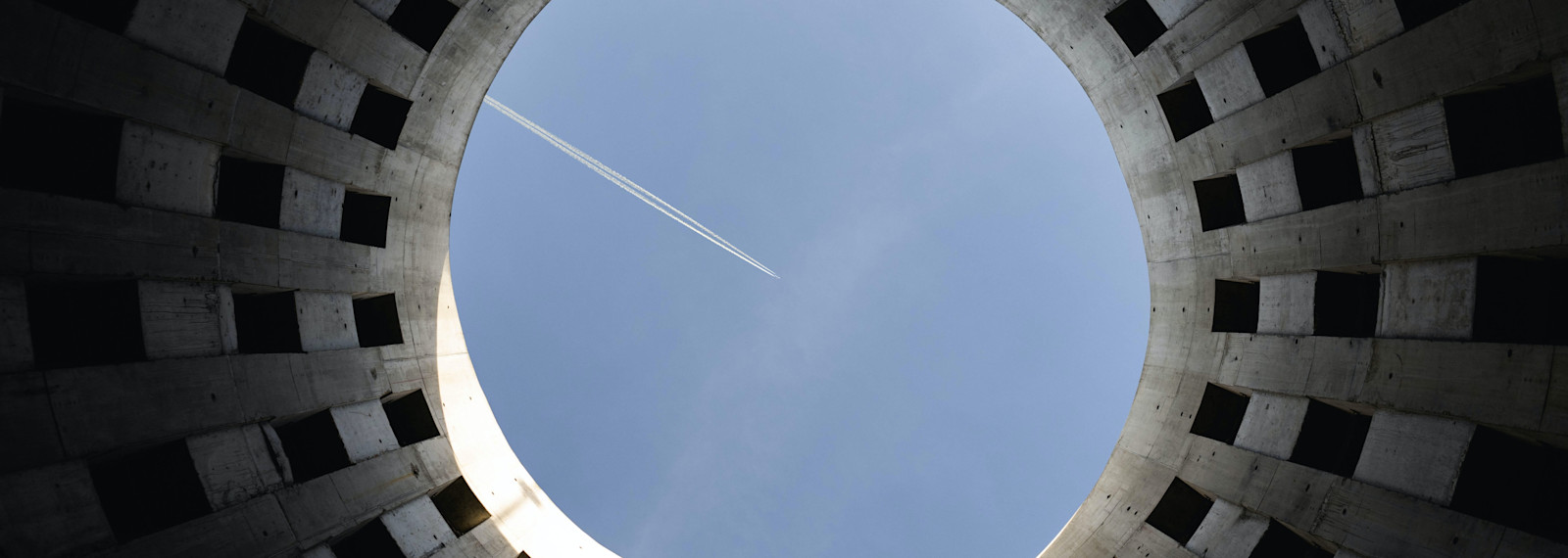 Image looking up to the sky from within a circular building