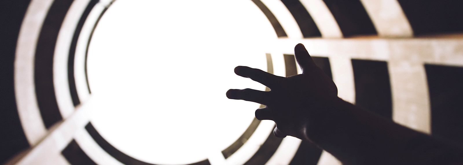 Hand reaching up to the atmosphere