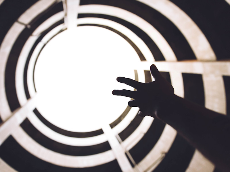 Hand reaching up to the atmosphere