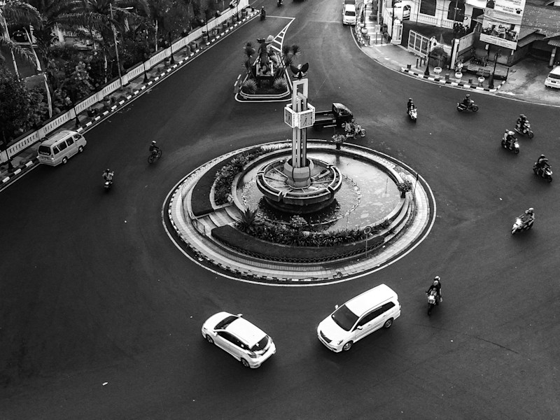 Image looking down at a roundabout with cars and cycles circling