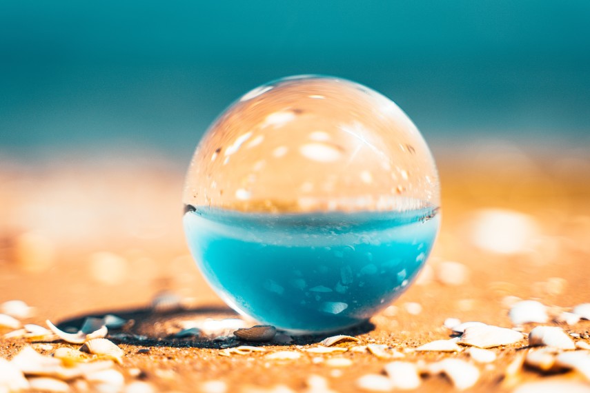 Image of a spherical, transparent object on a beach