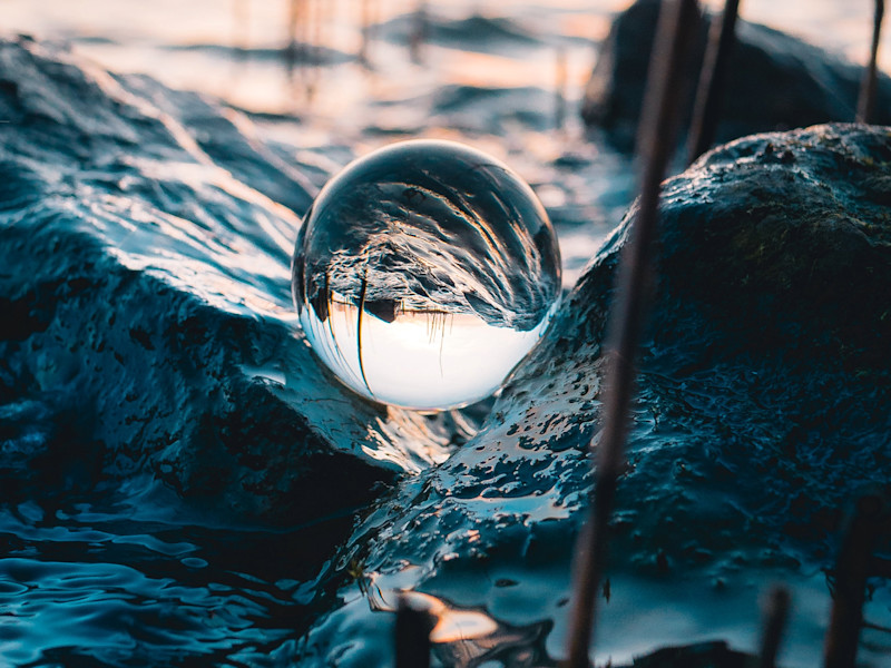 Image capturing a circular water bubble in waves