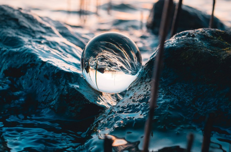 Image capturing a circular water bubble in waves