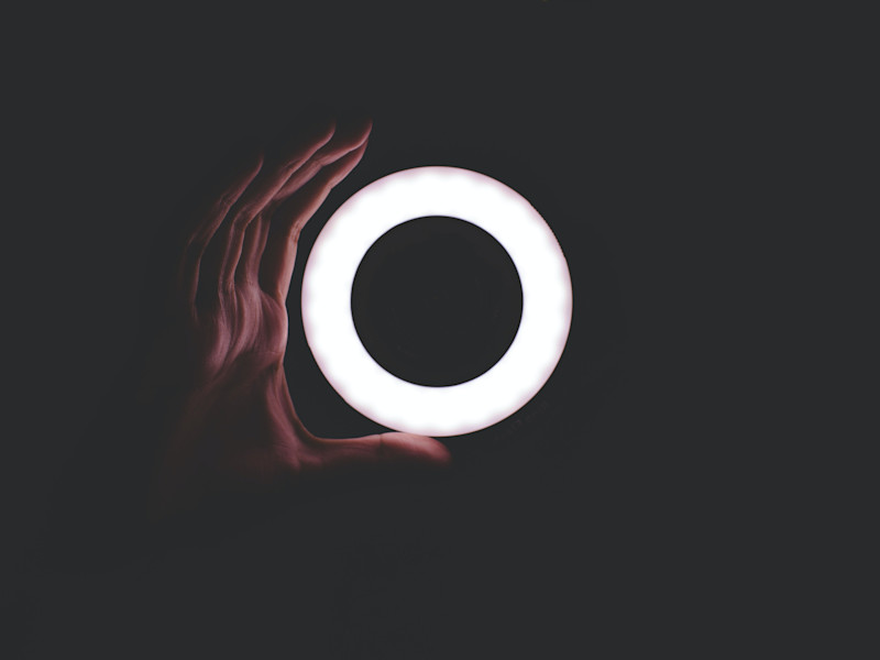 Image of a hand holding a circle of light